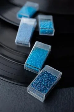Plastic transparent boxes with blue beads inside Stock Photos