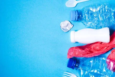 Plastic trash on blue background, Stock Photos