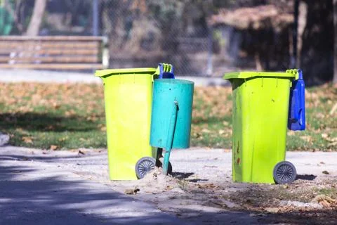 Plastic trash can in the park Stock Photos