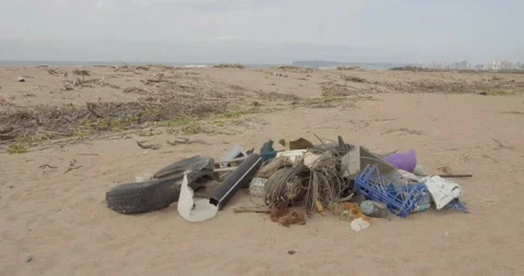 Plastic trash dumped on sand of beach and in ocean. Stock Footage 304433199
