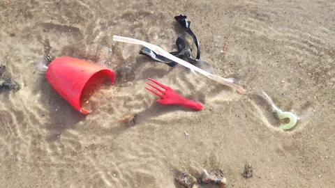 Plastic trash floats in the water. Ocean pollution with toxic waste. The concept Stock Footage 127151069