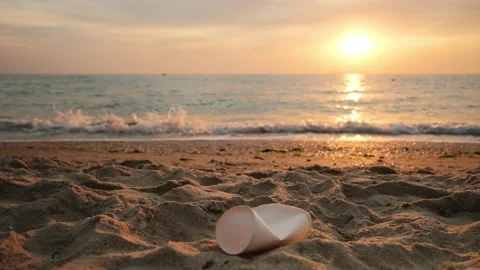 Plastic trash, garbage on the beach. Empty bottle, paper cups at sea shore Stock Footage 197540838