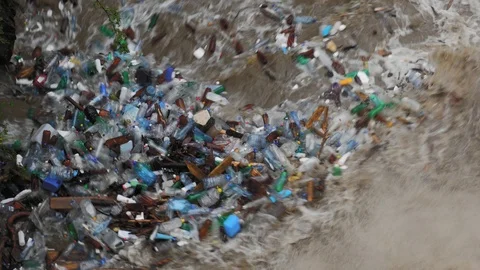 Plastic trash in mountain river (long, medium and close up) Stockbeeldmateriaal 109153485