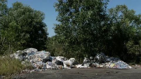 Plastic trash pile on the roadside of rural area Stock Footage 157803945