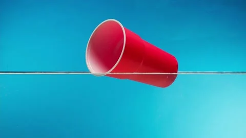 Plastic trash red glass floating in ocean, water pollution concept. Rubbish 库存影片 156875649