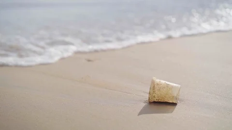 Plastic trash with wave breaking on beach, waste pollution concept Stock Footage 109023488