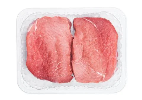 Plastic tray with fresh raw beef steak slices on white background Stock Photos