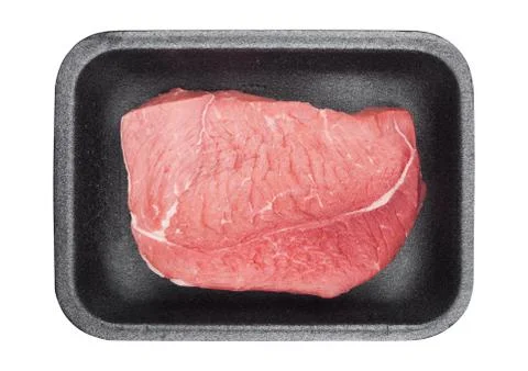 Plastic tray with fresh raw beef steak slices on white background Stock Photos