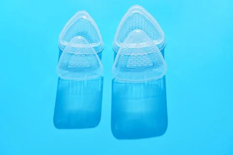 Plastic Triangular Onigiri Molds on a blue background 스톡 사진