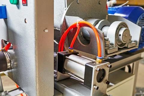 Plastic tubes of the pneumatic system connected to the pneumatic cylinder Stock Photos