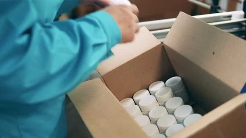Plastic tubs are getting relocated into a carton box Stock-Footage 154721686