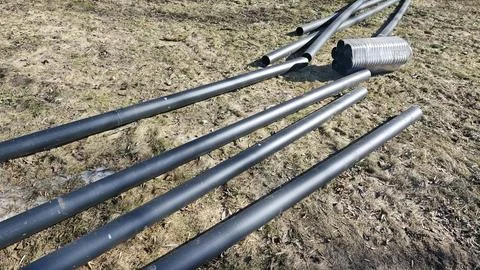 Plastic utility pipes on ground at construction site ready Stock Photos