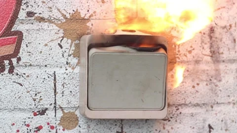 The plastic wall light switch on the wall lights up and melts. There was a short Stock Footage 153795763