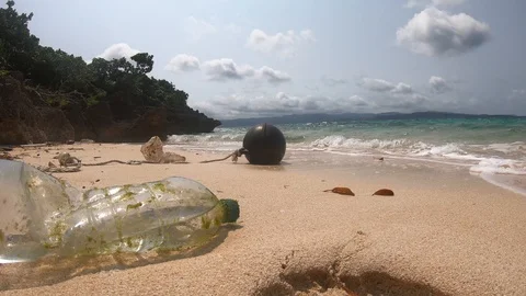 Plastic washed on a beautiful beach. A sad state of human waste. Stock Footage 106636428