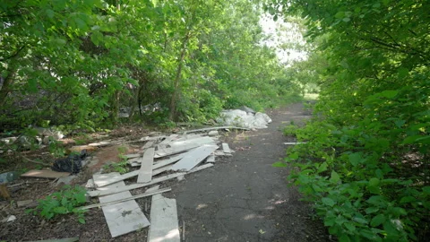 Plastic Waste and Construction Debris Dumped on Urban Park Path. Illegal Garbage Stock Footage 335225533