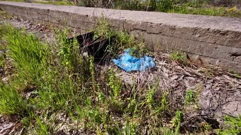 Plastic Waste and Garbage Polluting an Abandoned Outdoor Area Stock Footage 304696828