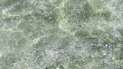 Plastic waste and microplastic debris polluting ocean water surface Video stock 333697080