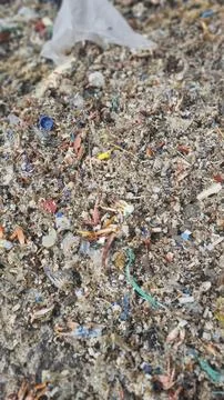 Plastic waste and microplastics cover the beach, causing severe ecological .. 스톡 사진
