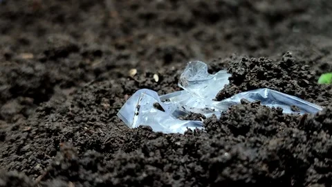 Plastic waste buried in the soil Stock Footage 322149409