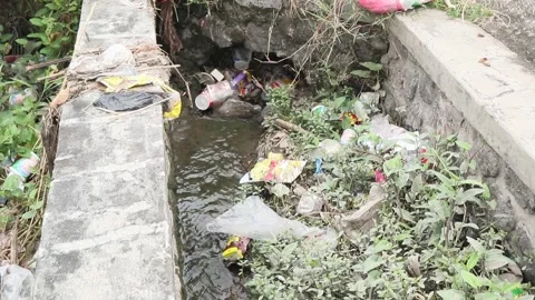 Plastic waste clogs waterways. Plastic waste in the gutter. Stock Footage 274123608