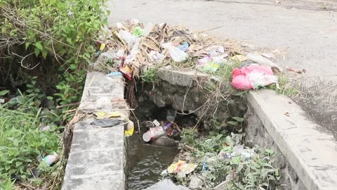 Plastic waste clogs waterways. Plastic waste in the gutter. Stock Footage 274123616