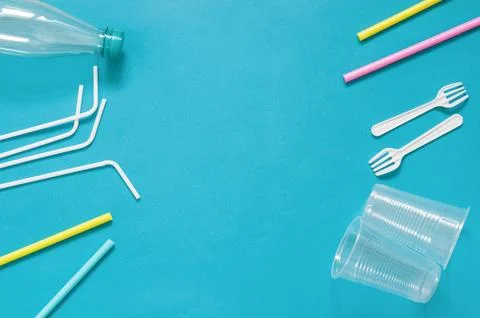 Plastic waste disposable tableware, ecological pollution. On a blue background. Stock Photos