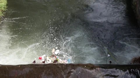 Plastic waste floating in a river. Plastic waste Stock Footage 306031091