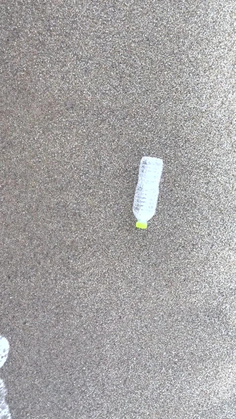 Plastic waste left on tropical beach as waves reach shore, careless human Stock-Footage 337411919