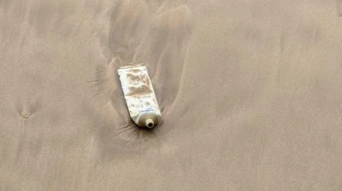 Plastic waste polluted sandy beach, the concept of saving the earth. Stock Photos