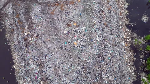 Plastic waste polluting environment dump with cows. Marvelous aerial view drone 스톡 동영상 332617048