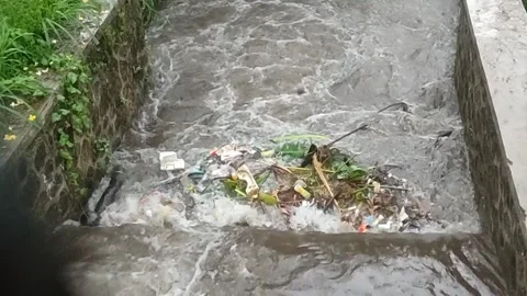 Plastic waste polluting river. Waste in river during flood Stock Footage 290485488