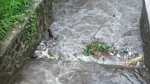 Plastic waste polluting river. Waste in river during flood Stock Footage 290485508