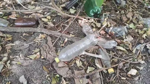 Plastic waste polyethylene bottles are thrown out in the forest in nature. The Stock Footage 283393907