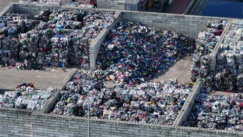 Plastic waste processing operations at recycling facility in industrial area Video stock 337984637