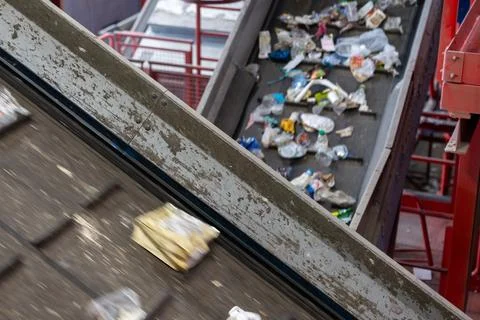 Plastic waste sorting conveyor system inside industrial recycling plant Stock Photos