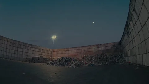 Plastic Waste Storage Area at a Recycling Facility Under Night Illumination Stock Footage 331166568
