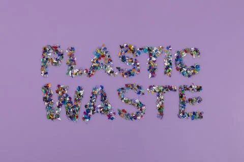Plastic waste text consisting of small plastic pellets collected from the sea 스톡 사진