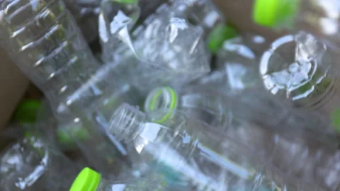 Plastic waste, Throwing a plastic waste bottle into a cardboard box Stock Footage 328249043