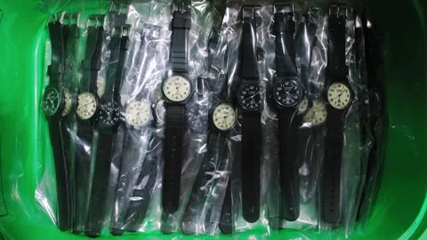 Plastic watches in plastic bag inside green plastic tray 스톡 동영상 254869501