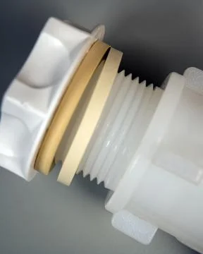 Plastic water ball valve thread ends on gray background. Stock Photos