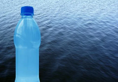 Plastic water bottle on the background of waves on the pond, collage, with pl Stock Photos