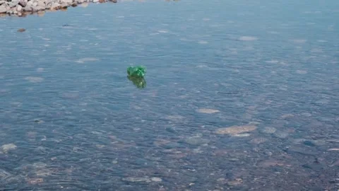 Plastic water bottle floats down the river into the sea. Plastic garbage Stock Footage 270805466