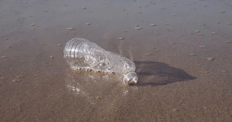 Plastic water bottle garbage on the ocean beach Stock Footage 124749958