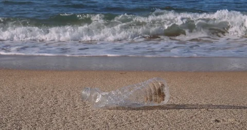 Plastic water bottle garbage on the ocean beach Stock Footage 124750051