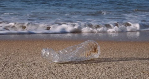 Plastic water bottle garbage on the ocean beach Stock Footage 124750280