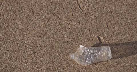 Plastic water bottle garbage on the ocean beach Stock Footage 124751645