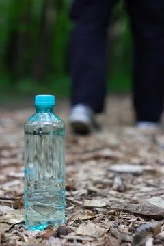 A plastic water bottle on a path Stock Photos