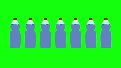 Plastic water bottles aligned on green background Stock Footage 307623063