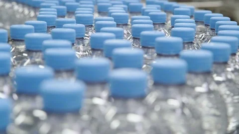Plastic water bottles on conveyor machine industry. Stock Footage