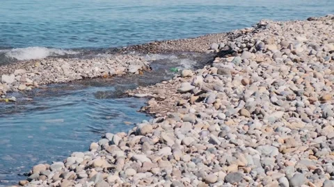 Plastic water pollution. Plastic bottle floats down the river into the sea Stock Footage 270805889